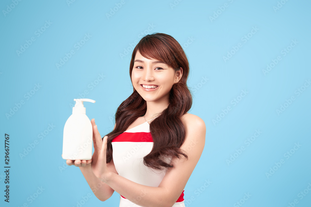 Beautiful Asian asian woman holding and presenting white cosmetic tube, Beauty skin care concept Beautiful Asian asian woman holding and presenting white cosmetic tube, Beauty skin care concept