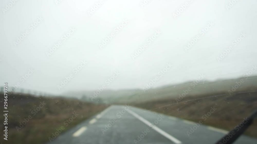 Slow motion of windscreen wipers on left traffic road on rainy day