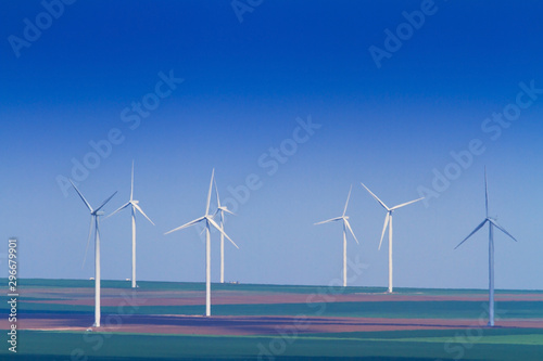 Wind turbines profiled on vlear sky in summer
