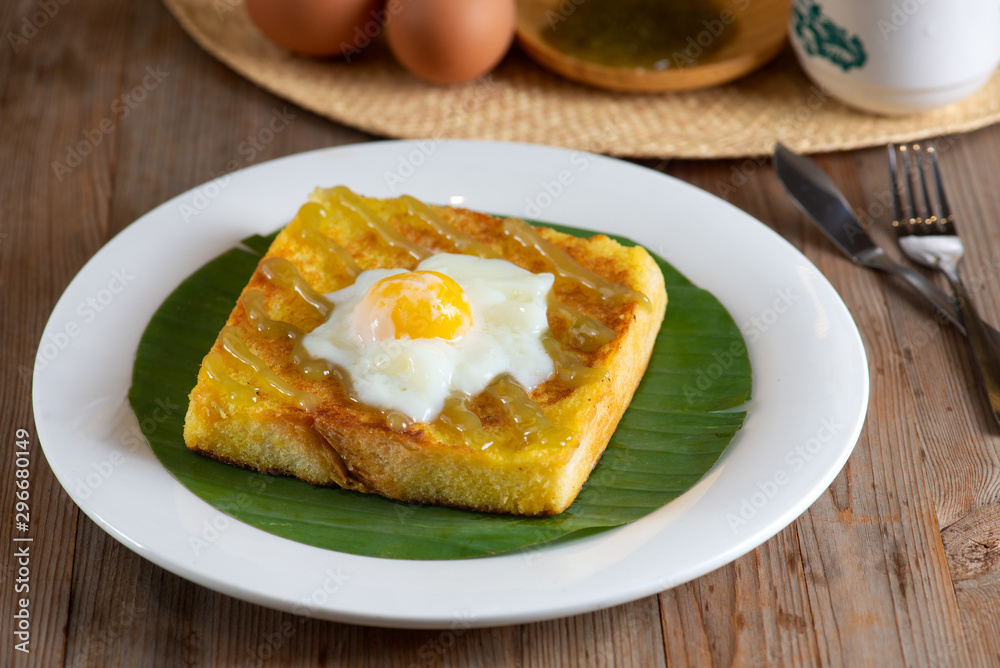 Traditional Malaysian style breakfast, kaya butter toast with half boiled eggs Traditional Malaysian style breakfast, kaya butter toast with half boiled eggs