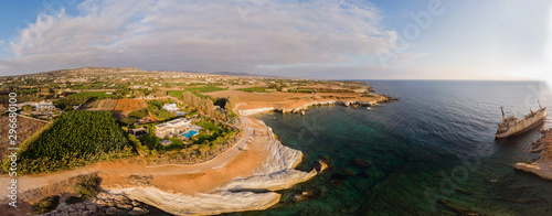 Aerial view of the abandoned ship EDRO III in Pegea, Paphos, Cyprus. Rusty shipwreck stranded on the rocks in intercostal Peyia sea caves, coral Bay, Paphos, standing at an angle to the shore.