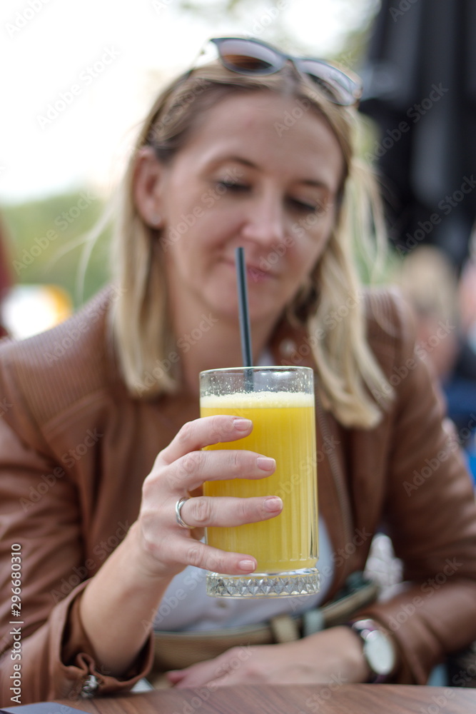 Portrait of the mature woman sitting in the restaurant drinking juice Portrait of the mature woman sitting in the restaurant drinking juice