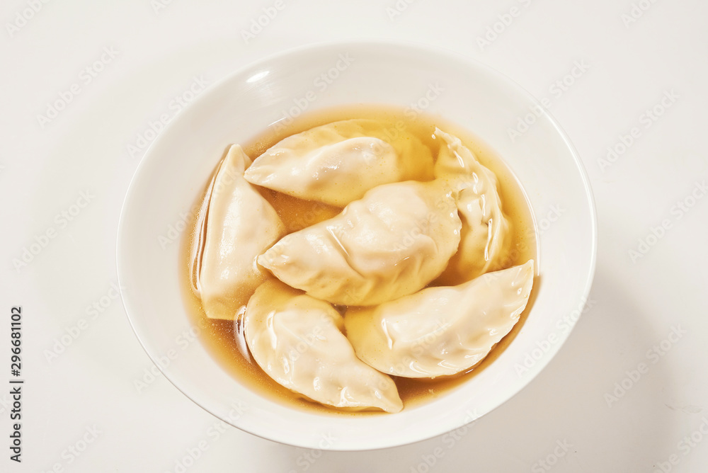 Simple bowl of dumpling soup with white background Simple bowl of dumpling soup with white background