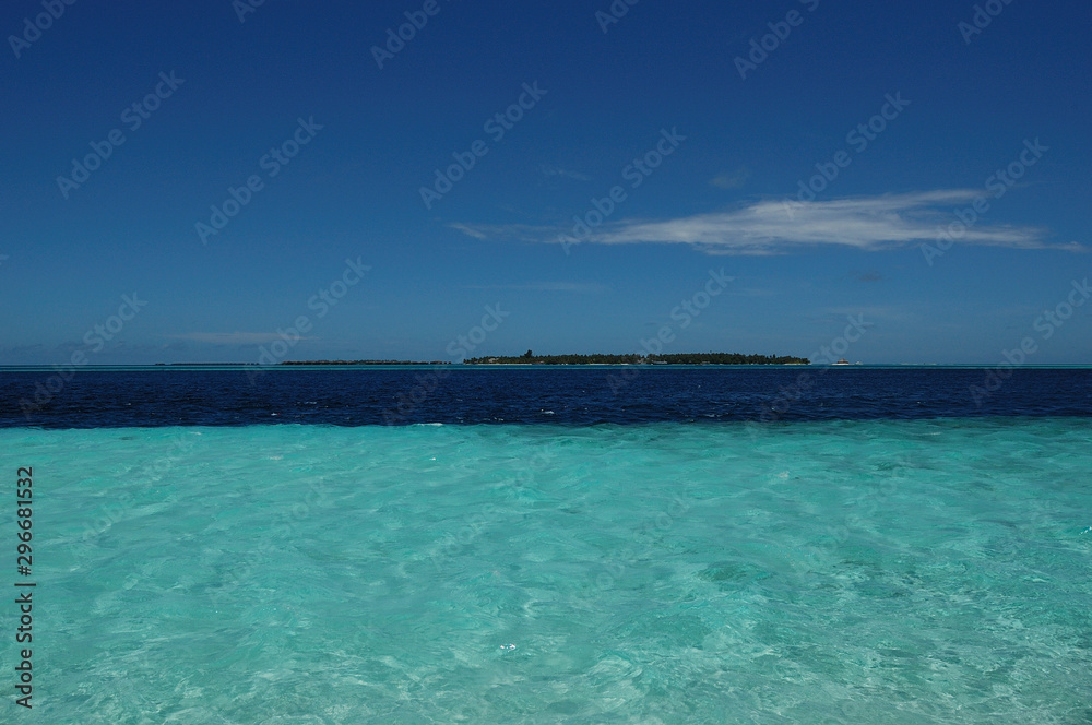 The ridge of an island seen through the clear waters of the Maldives The ridge of an island seen through the clear waters of the Maldives