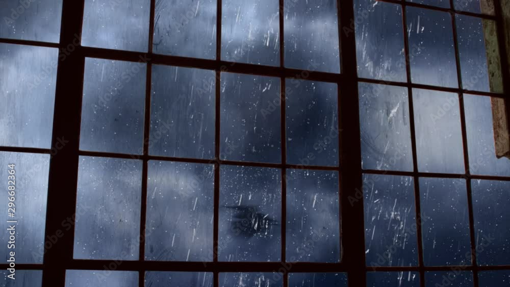 Scary Bat filled Sky Outside Old Factory Window 4K Loop features a view out of an old factory window of rolling clouds and bats flying with a full moon in a loop
