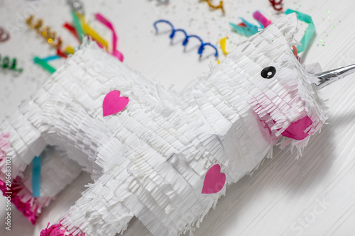 Unicorn pinata over a white wood texture 