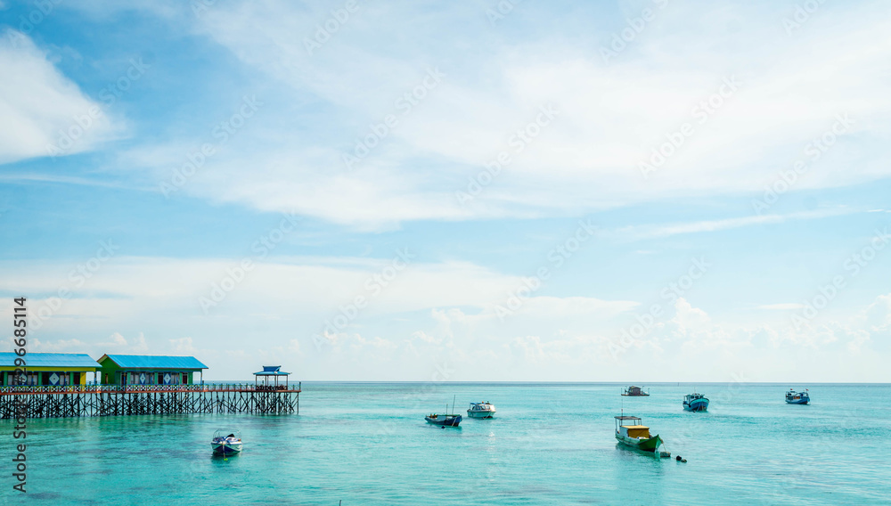 beautiful scenery at Derawan Island. Boats docked in the port with crystal clear water
