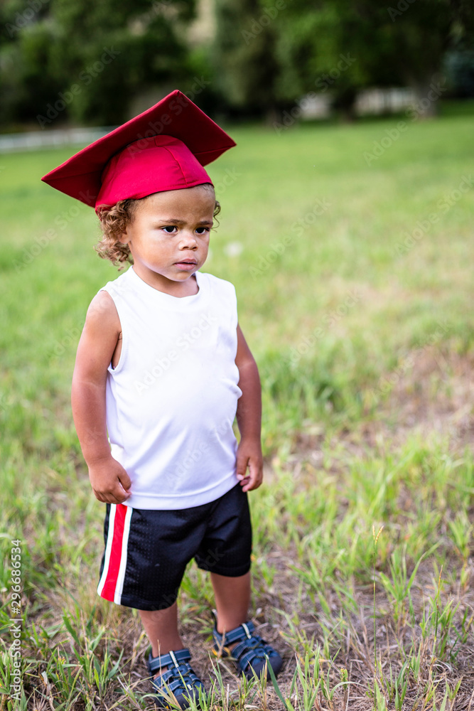 Cute little boy of African descent dreaming of a successful academic career. Education Concept photo of a diverse child serious about school Cute little boy of African descent dreaming of a successful academic career. Education Concept photo of a diverse child serious about school