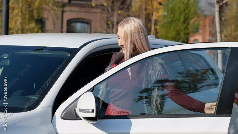 Happy Business Woman Gets in Her Premium Class Car and waving hand Happy Business Woman Gets in Her Premium Class Car and waving hand