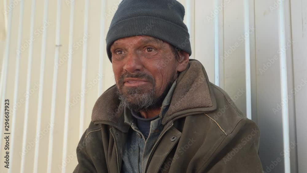 Homeless man crying with tears during a conversation on the street Homeless man crying with tears during a conversation on the street