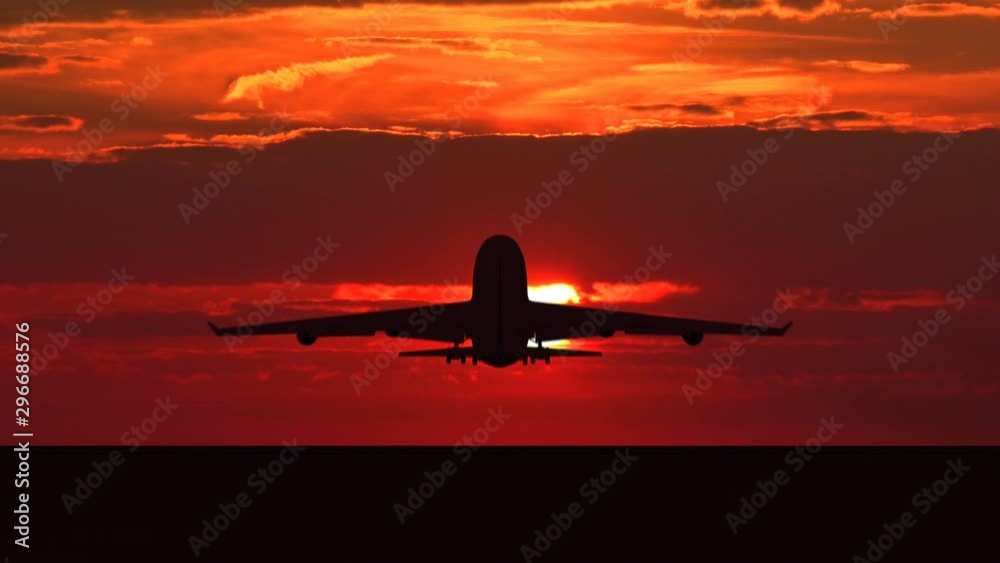 Large passenger airplane taking off and flying towards scenic orange sunset. Suitable as an iillustration for tourism, holidays, vacation, success, business and transportation concept video