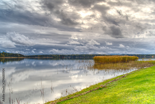 Beautiful cloudscape over the sea from green grass. Baltic Sea HDR photo