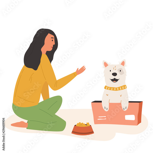 Young cute volunteer girl feeding street dog