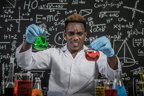 Scientists hold beakers with green and red chemicals and stressed faces.