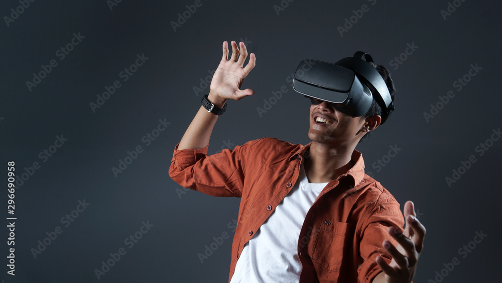 Man playing game using virtual reality glasses in the dark room of the playing club Man playing game using virtual reality glasses in the dark room of the playing club