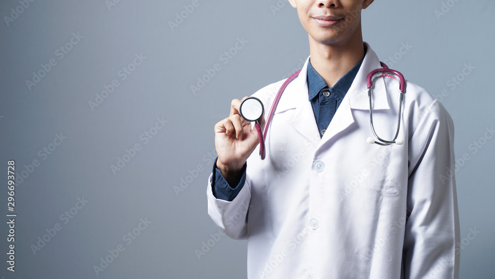 Close up smiling professional doctor with stethoscope in grey background Close up smiling professional doctor with stethoscope in grey background