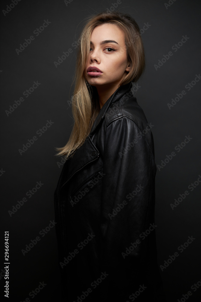 Fashion portrait of a sexy blonde woman with a make up wearing black clothes Fashion portrait of a sexy blonde woman with a make up wearing black clothes