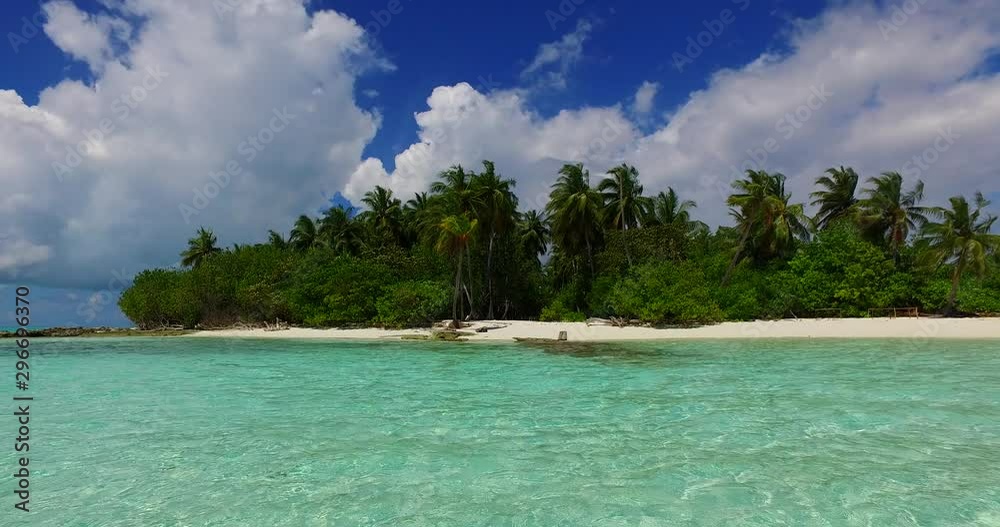 Isolated island with palm trees surrounded by crystal turquoise water of Pacific Ocean Isolated island with palm trees surrounded by crystal turquoise water of Pacific Ocean