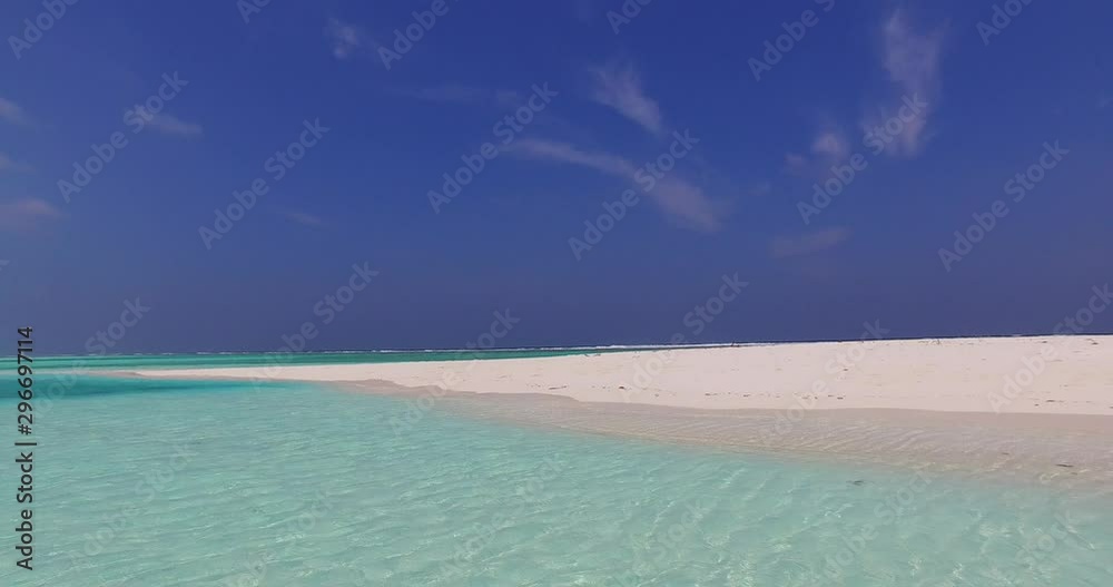 turquoise crystal clear seawater and white sandbank. Tropical beach background, tilting up shot