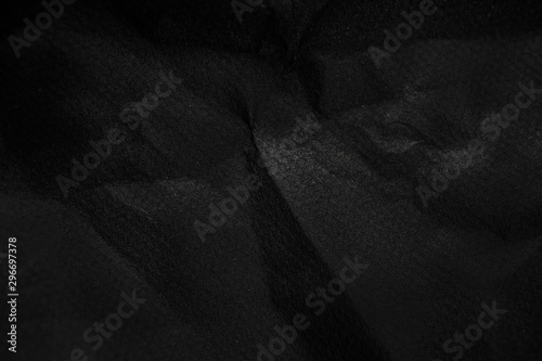 black wrinkled paper texture  background. Crumpled black paper surface