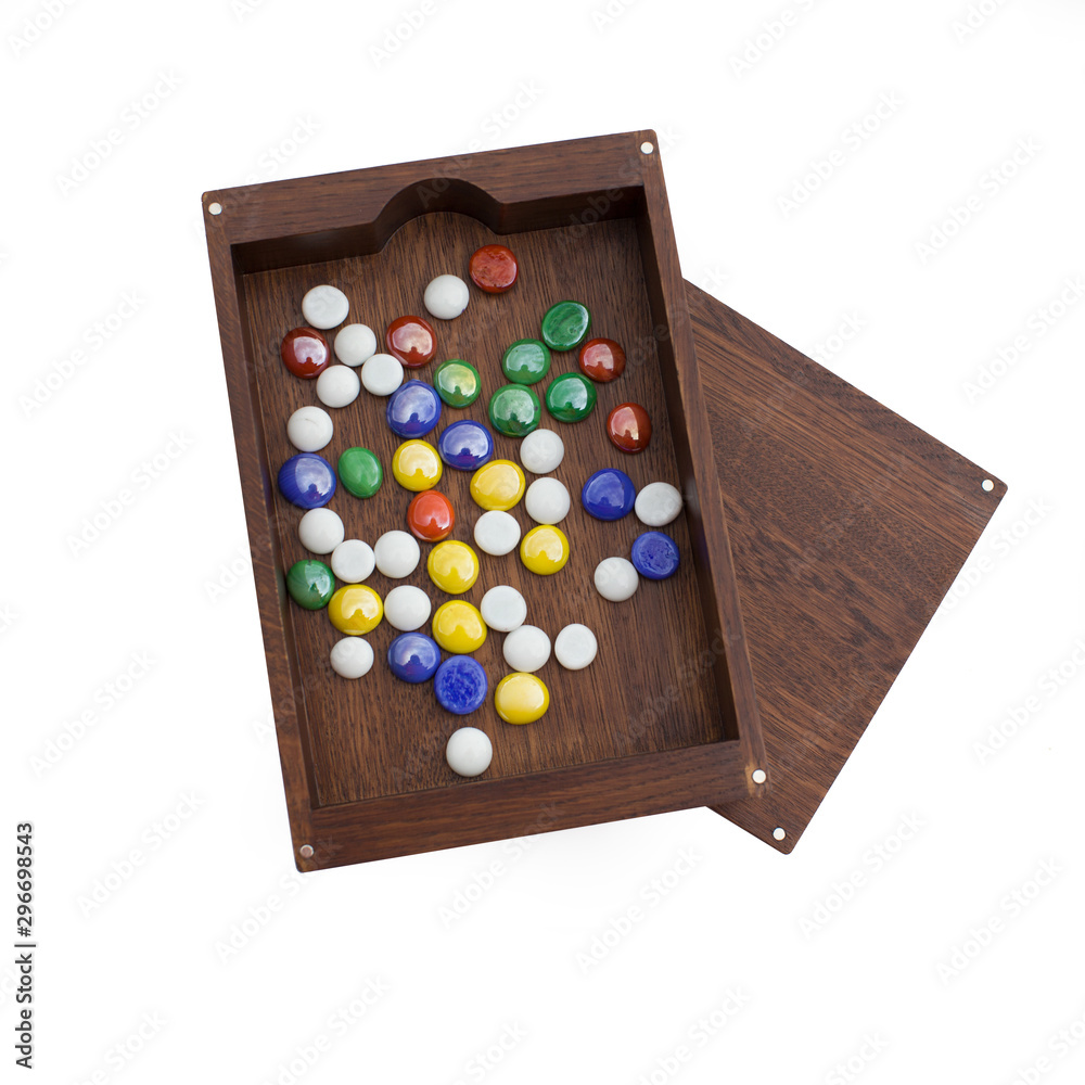 Isolated wooden box with colored stones on white background. Isolated wooden box with colored stones on white background.