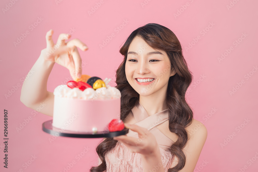 Generous woman holding birthday cake front pink background Generous woman holding birthday cake front pink background