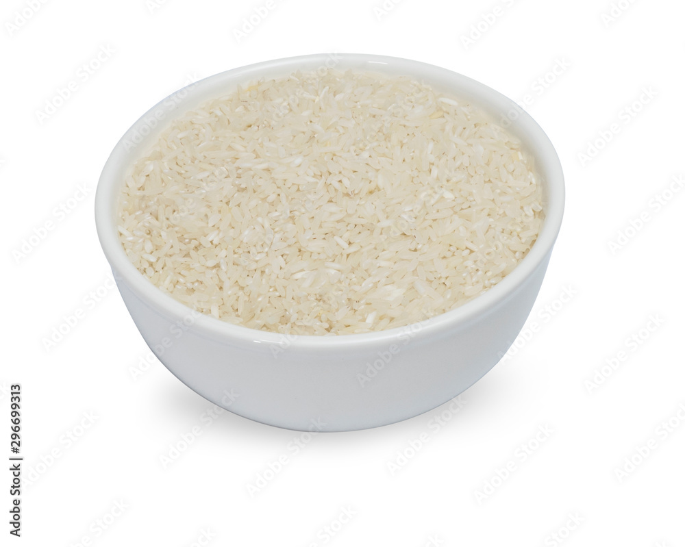 uncooked rice in white ceramic bowl on white background. uncooked rice in white ceramic bowl on white background.