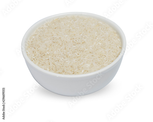 uncooked rice in white ceramic bowl on white background.
