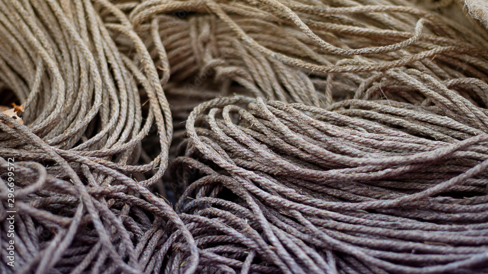 Rough Cord made from natural plant fiber. Rope detail, closeup. Horizontal. Orange and violet duotone. Copy space. Wallpaper and background about fabtic manufacture, eco friendly material. Banner