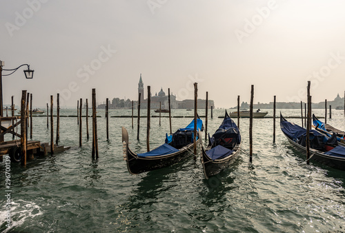 Venice, gondolas moored in Venetian lagoon (Canale della Giudecca) and the island of San Giorgio Maggiore. UNESCO world heritage site, Italy, Europe