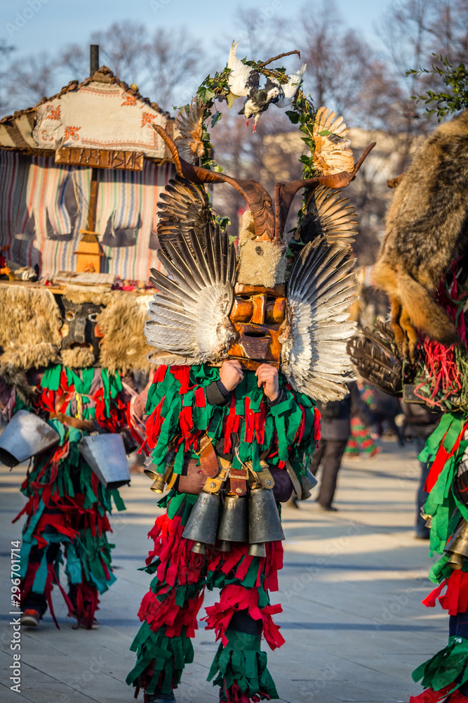 Mummers perform rituals to scare evil spirits at Surva festival at Pernik in Bulgaria. The people with the masks are called Kuker (kukeri). Wood mask with feathers, pigeon.