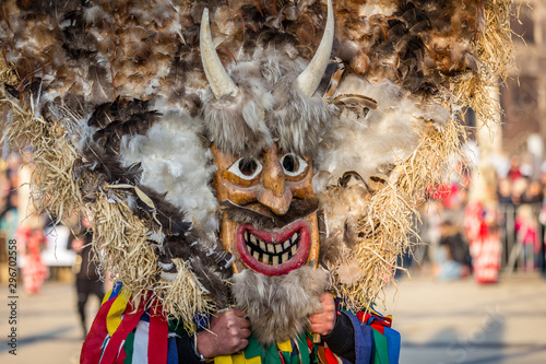 Mummers perform rituals to scare evil spirits at Surva festival at Pernik in Bulgaria. The people with the masks are called Kuker (kukeri). Mask made of wood feathers and horns.