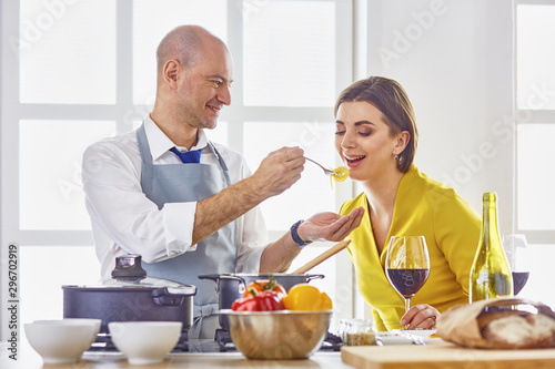 Smiling young couple cooking food in the kitchen