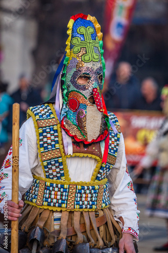 Mummers perform rituals to scare evil spirits at Surva festival at Pernik in Bulgaria. The people with the masks are called Kuker (kukeri). Colorful mask.