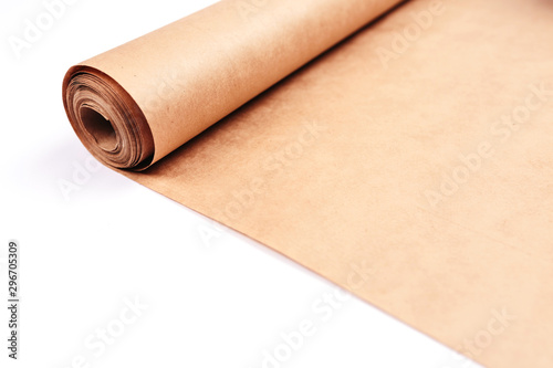 Twisted into roll brown wrapping paper on white background