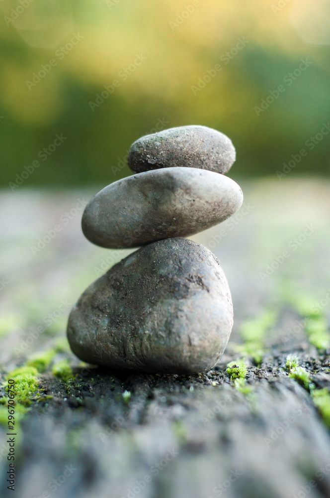 Closeup of stone balance of pebbles on wooden table in outdoor Closeup of stone balance of pebbles on wooden table in outdoor