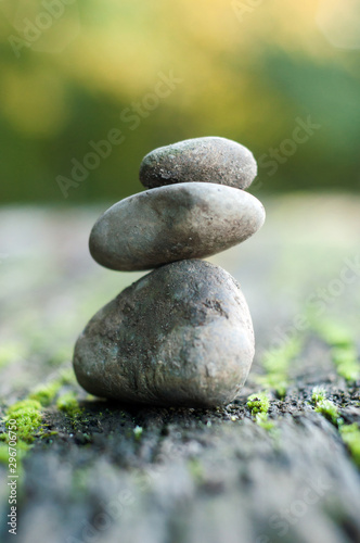 Closeup of stone balance of pebbles on wooden table in outdoor