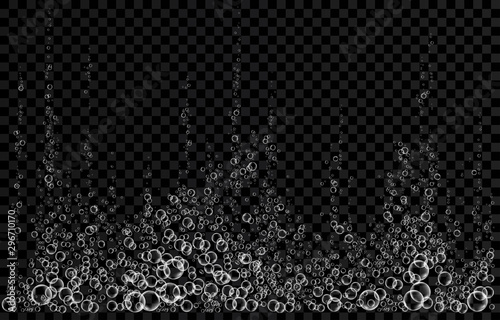 White fizzing air bubbles in water on black  background. .