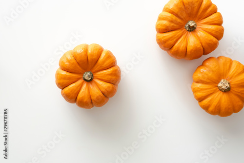 Mini pumpkins lay on white background.