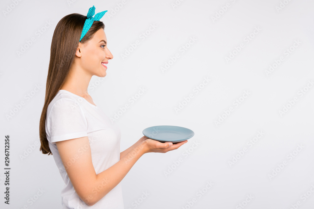 Close-up profile side view portrait of her she nice attractive lovely cheerful cheery girl holding in hands empty plate order useful organic product copy space isolated on light white color background