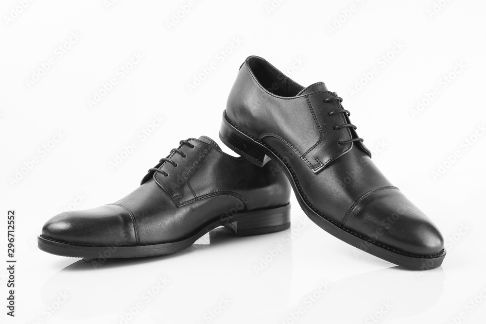 Pair of black shoes isolated on white background, top view.