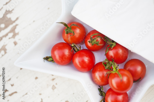 wooden background plate of brie cheese and cherry tomatoes