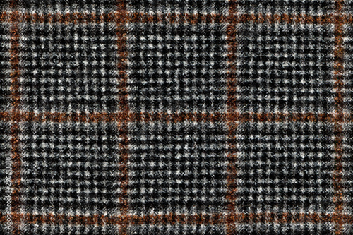 Modern Winter jacket. Black and Brown Glenurquhart check is made of woolen fabric. Herringbone tweed, Wool Background Texture. Coat close-up. Expensive men's suit. High resolution