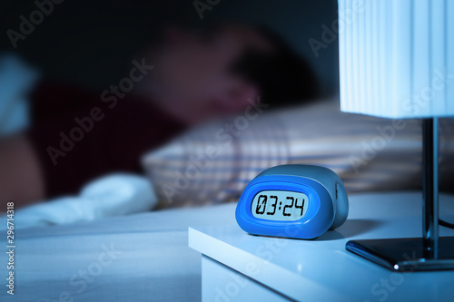 Schilderij op canvas Close up to digital alarm clock on nightstand in bedroom