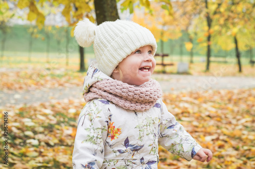 Happy little girl in autumn park