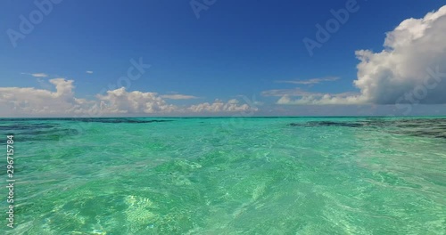 Tropical beach abstract background. White sandy beach on the Maldives, cristal clear emerald water photo