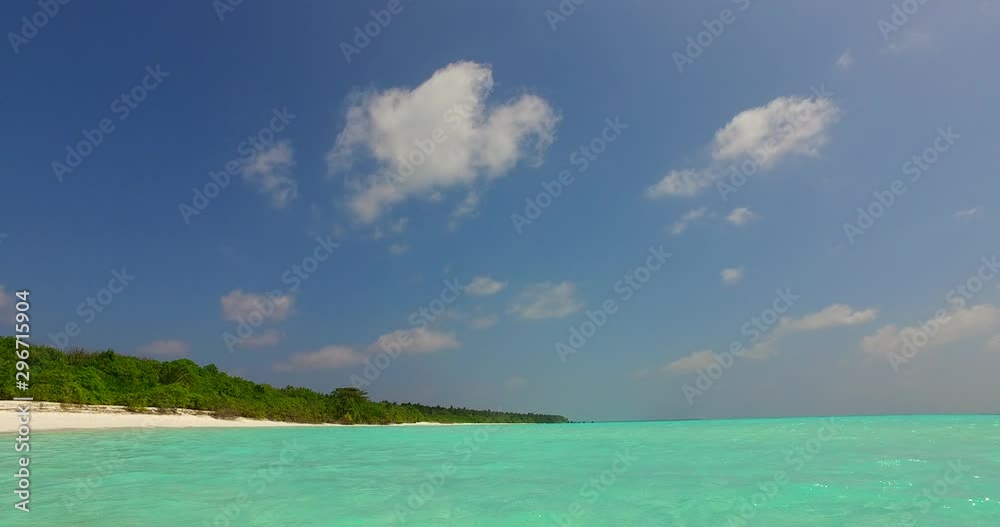 Slowly moving dolly shot of an exotic island with green vegetation and turquoise waters in Hawaii 4K Slowly moving dolly shot of an exotic island with green vegetation and turquoise waters in Hawaii 4K