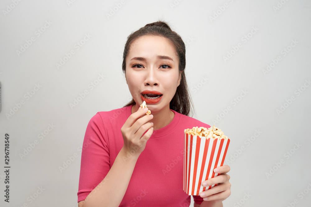 Young asian woman desperate and sad. She is holding a popcorns bucket. Young asian woman desperate and sad. She is holding a popcorns bucket.