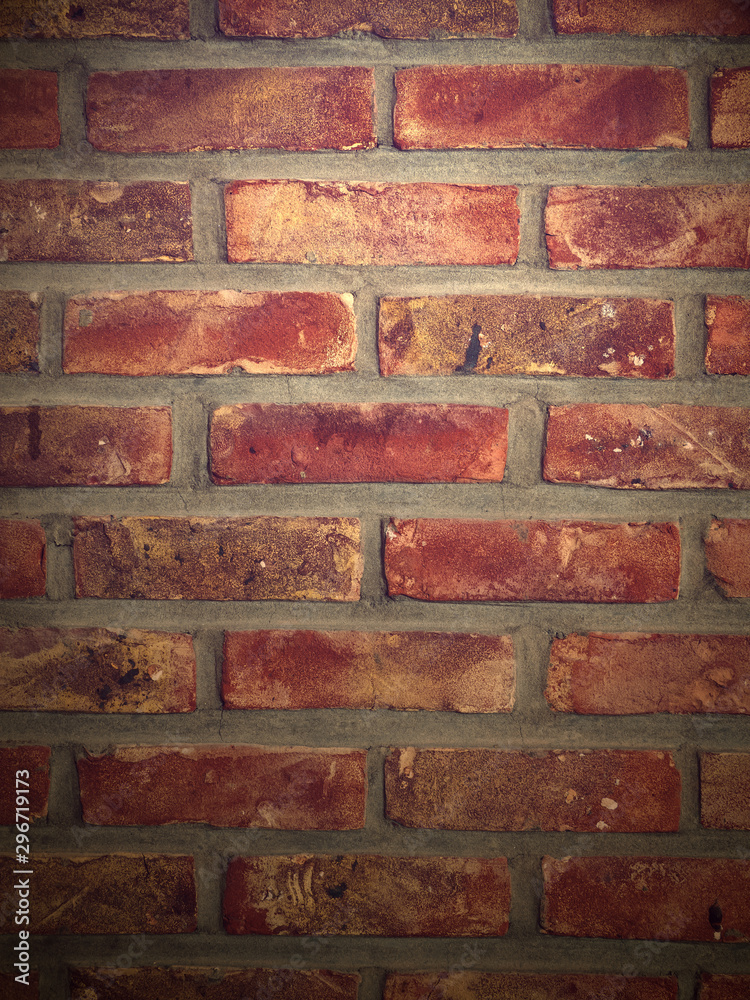 Fototapeta premium Light shining on interior brick wall