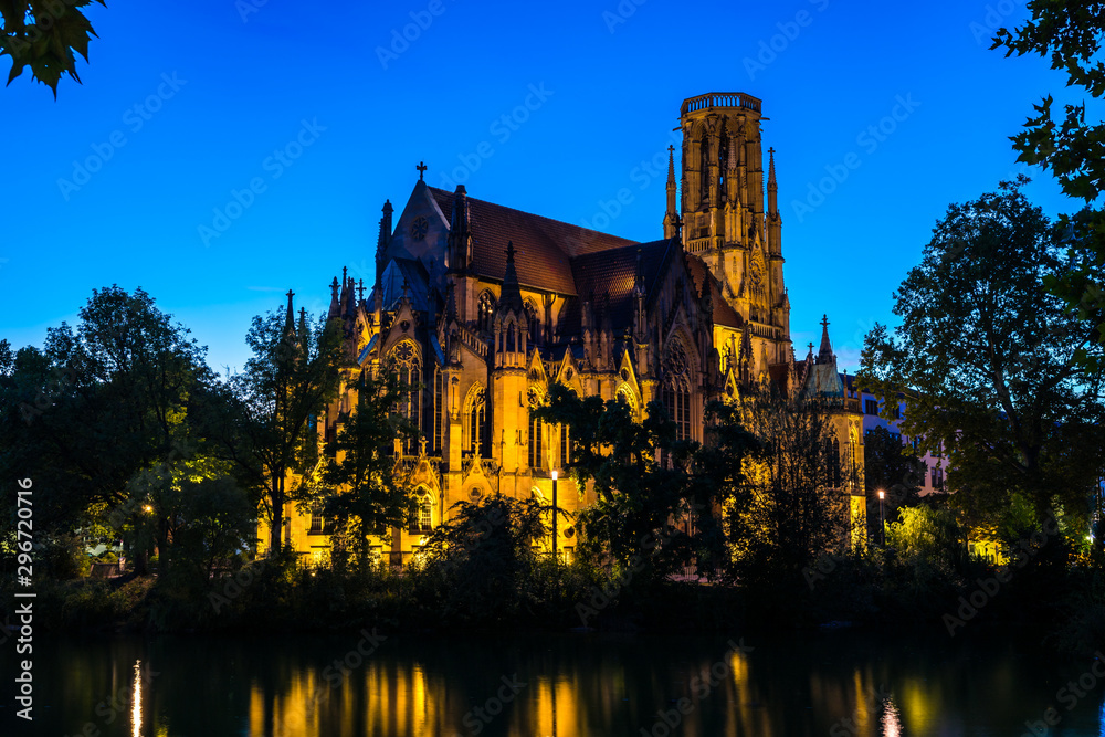 Germany, Popular stuttgart feuersee church of st john gothic building illuminated by night in downtown reflecting in water of lake